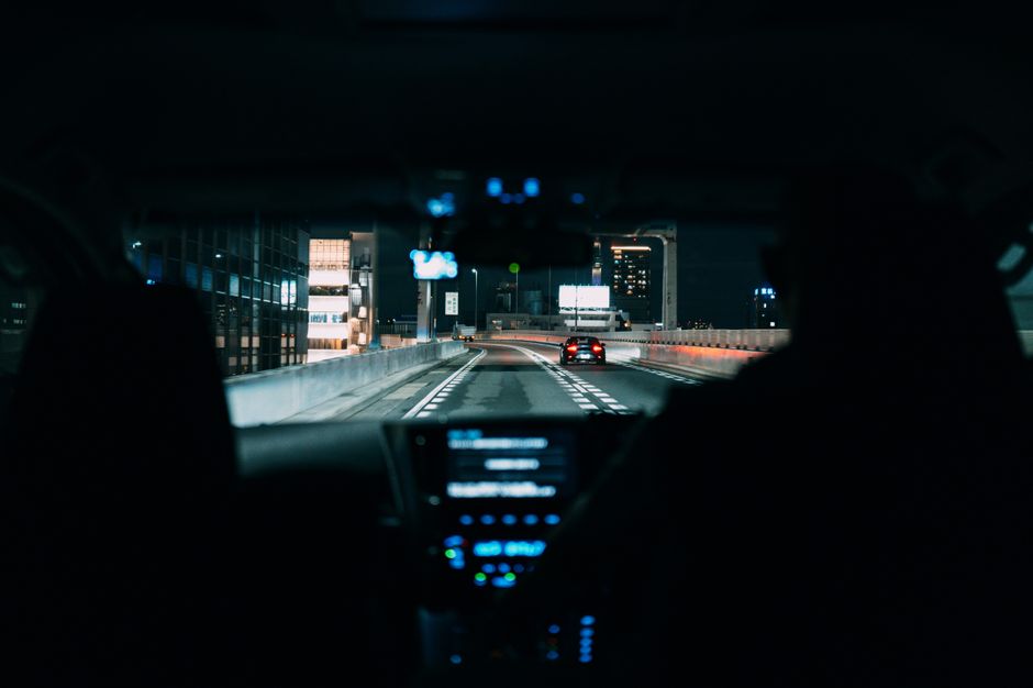 Segurança Pública São Paulo. — View from inside a car driving on a city highway at night, highlighting urban life.
